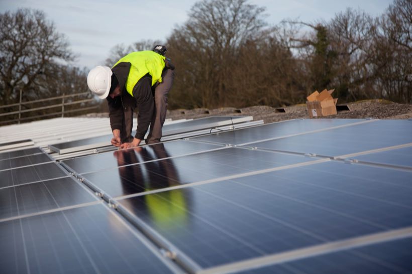 An electrical installation crew working on a roof